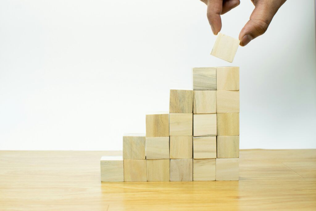 https://unsplash.com/photos/a-person-placing-a-piece-of-wood-into-a-pyramid-vsLbaIdhwaU